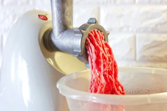 canva grinding red meat in mincer machine on white background MAD60Qz H0o