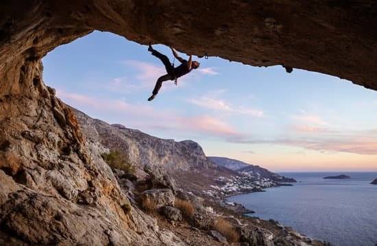 canva male climber climbing along roof in cave MADasZTKKqE