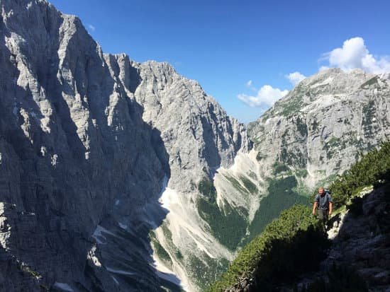 canva man climbing rocky mountain