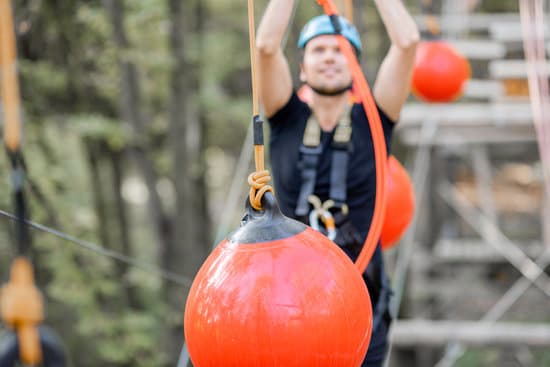canva man climbing ropes with balls in the park