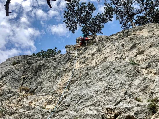 canva man doing rock climbing activity