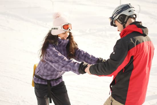 canva man teaching a woman to snowboard in the snow MAEX6f54 7M