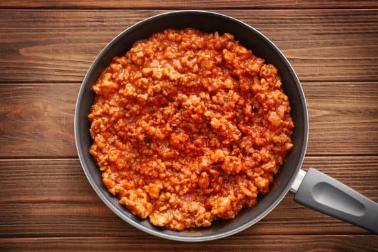 canva meat sauce in frying pan on wooden background MAD9T0It tM
