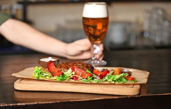 canva meat with garnish on wooden board with glass of beer MAD Qhje8b4