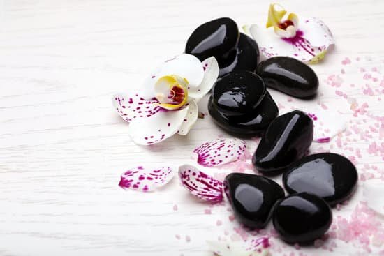 canva orchids and zen stones on wooden background MAD Mlrkgbw