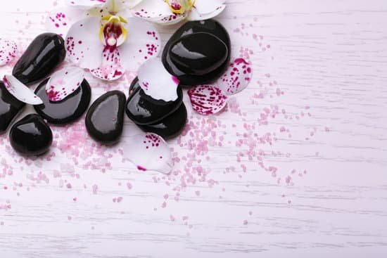 canva orchids and zen stones on wooden background MAD Mly3FeU