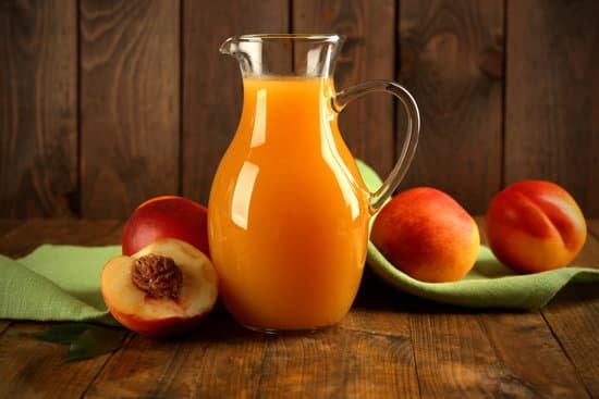 canva peach juice and ripe peaches on wooden background MAD