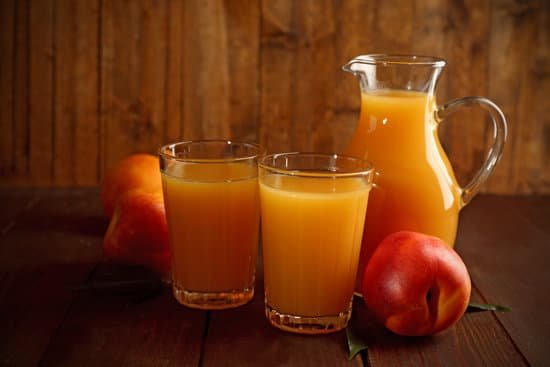 canva peach juice and ripe peaches on wooden background MAD MuREcWk