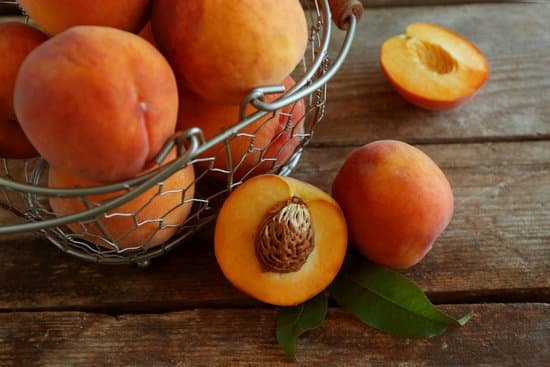 canva peaches in basket on wooden background MAD