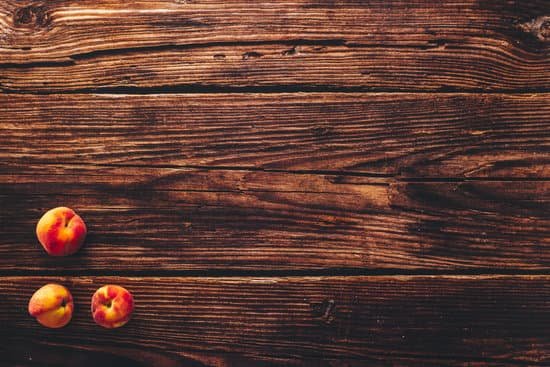 canva peaches on a wooden table MAD lPZN7MM