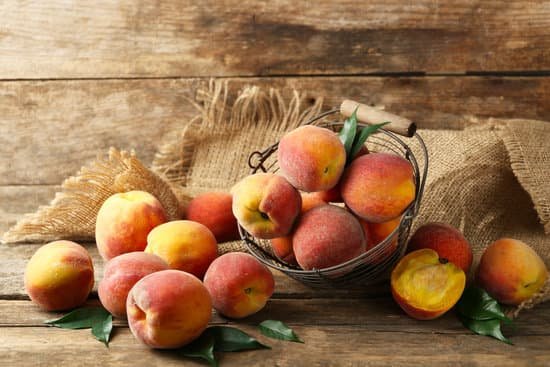 canva peaches on wooden background MAD MTijb2A