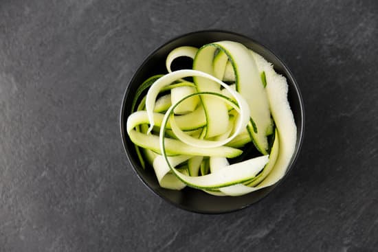 canva peeled zucchini in a ceramic bowl MAEPmgBMolA