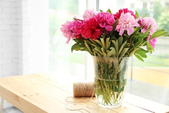 canva peony bouquet on wooden table MAD QzIpmK4