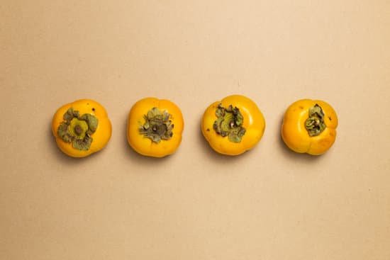 canva persimmon fruit on brown background MAELSyqsgvo