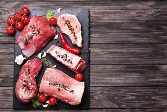canva pieces of different fresh meat on kitchen table