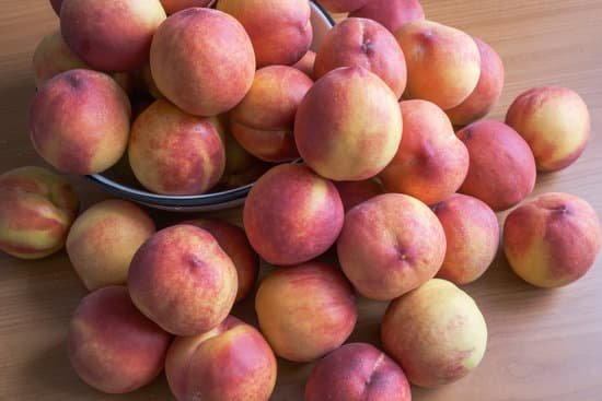 canva pile of peaches on wooden table MAEB nURDF4