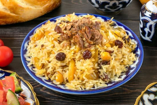 canva plate of rice pilaf with meat on wooden table MAD VX 7ig8