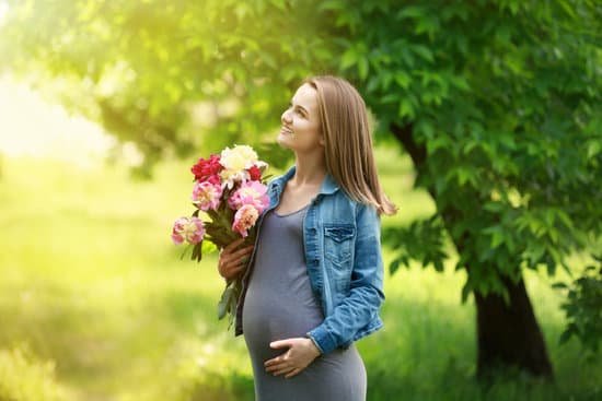 canva pregnant woman with peony bouquet outdoors MAD Q39yHoQ