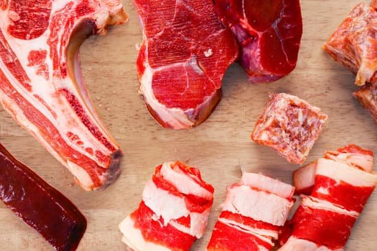 canva raw meat sliced in various shape on wooden table MAD6vIhM8DA