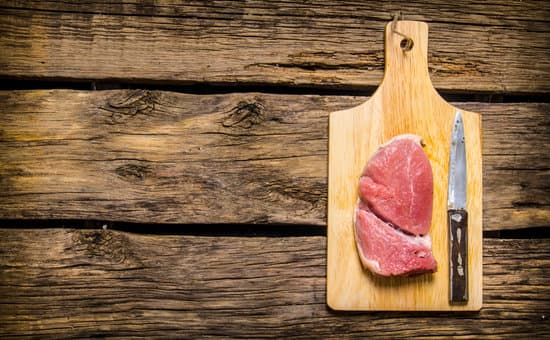 canva raw meat steak with knife on cutting board MAESqrjFCnU