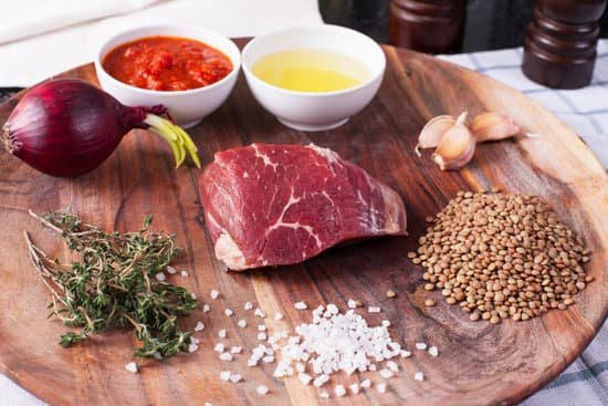 canva raw meat with ingredients and condiments on wooden board MAEMmREGCl8