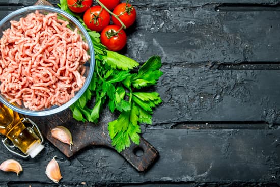 canva raw minced meat in a bowl with parsley and tomatoes MAEPzOi1muo