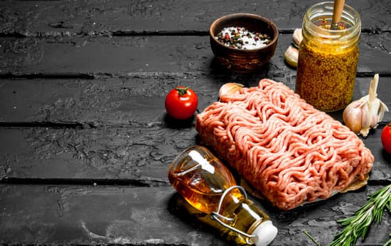 canva raw minced meat with spices and jar of mustard. MAEPmLEAbT0