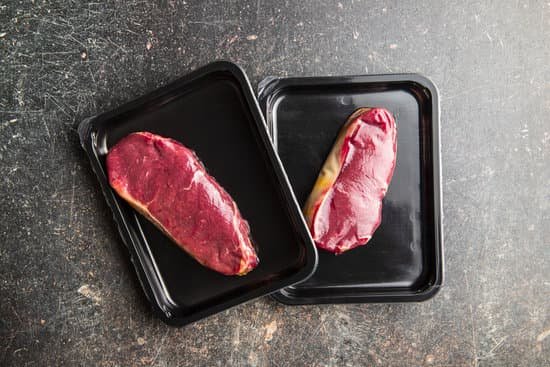 canva raw slabs of meat on trays flatlay MAEAtfwAw9Q