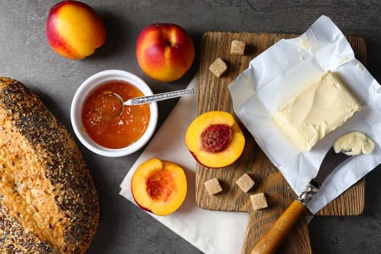 canva ripe peaches butter crackers and fresh bread on wooden table MAD MqKjlkk