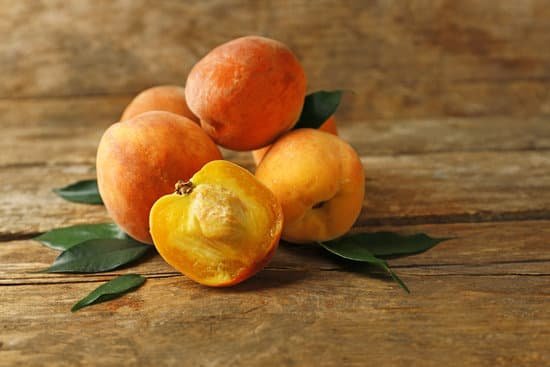 canva ripe peaches on a wooden table MAD MbSaBMc