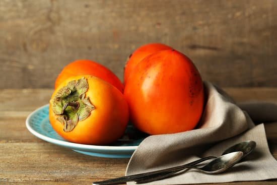 canva ripe sweet persimmons on a plate MAD L0hMaDQ