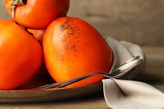 canva ripe sweet persimmons on wooden table MAD L1l2ys4