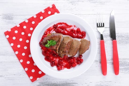 canva roasted meat with cranberry sauce on plate MAD MZ0W0Pg
