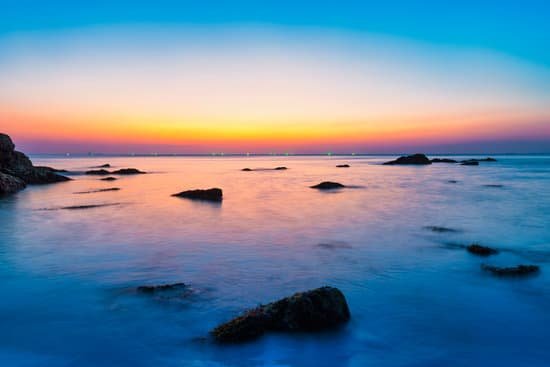 canva rocks in the sea at sunset MAEFyu5qb4I