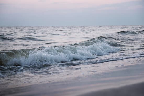 canva sea wave on the shore at sunset MAD MlKX4MA