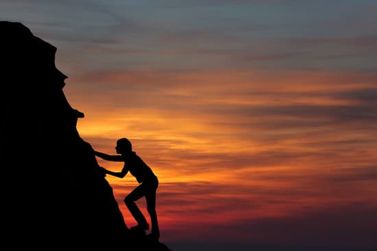 canva silhouette of person climbing a mountain at sunset MAEPGSmul50