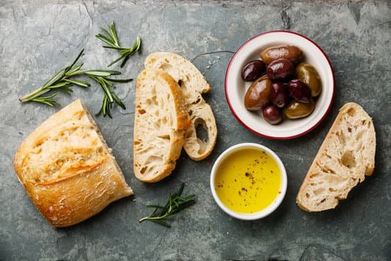 canva sliced fresh bread ciabatta with olive oil olives and rosemary MADPJVJ0yTo