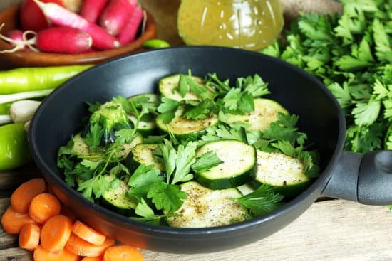 canva sliced zucchini in pan on table with greens MAD McRXlZw