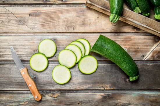 canva sliced zucchini with a knife flatlay MAEPnDmzd0Q