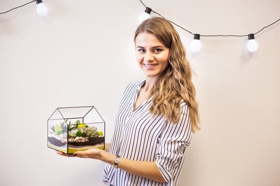 canva smiling woman holding a terrarium in a glass MAEMKBktDts