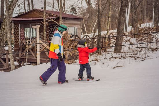 canva snowboard instructor teaches a boy to snowboard MAELB2PXJcI