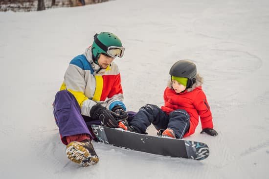 canva snowboard instructor teaches a boy to snowboard MAELB3oT028