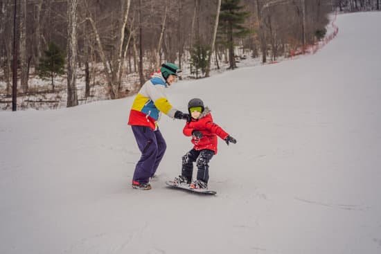 canva snowboard instructor teaches a boy to snowboarding MAELB 4FrvY