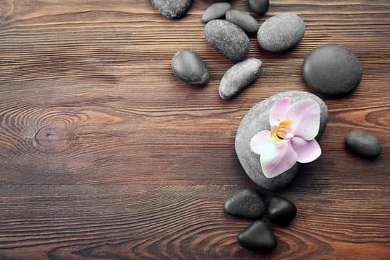 canva spa stones and orchid flower on wooden background MAD QqGgv5s