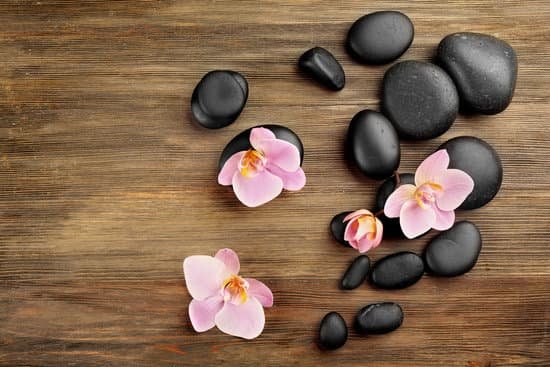 canva spa stones and orchid flowers on wooden background MAD Qs0LX2s