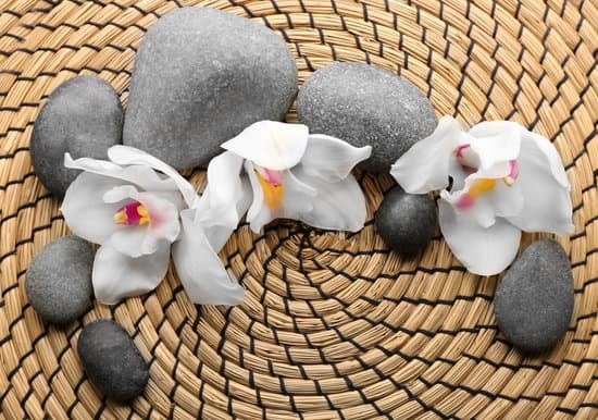 canva spa stones and white orchid on a wicker mat MAD Qk9i8rI