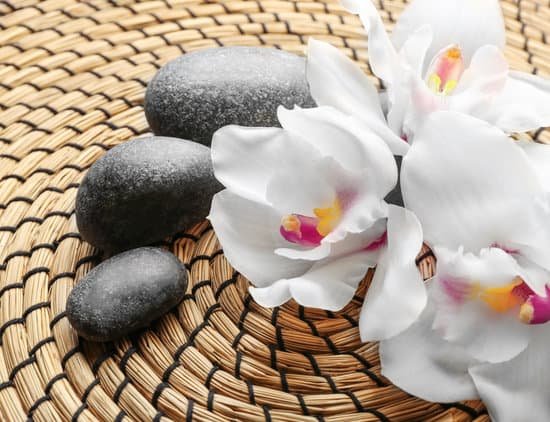 canva spa stones and white orchid on a wicker mat closeup MAD QhsFy7Q