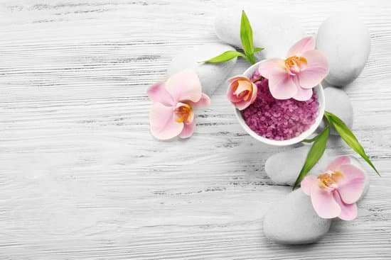 canva spa stones sea salt and orchid flowers on wooden background MAD QteoLFg