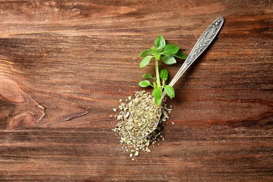 canva spoon with aromatic dried oregano on wooden background MAD9Tz9ssRs
