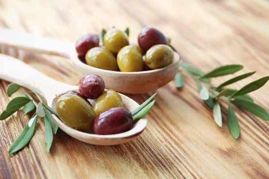 canva spoons with green and red olives on a table MAD9UEzI6wg